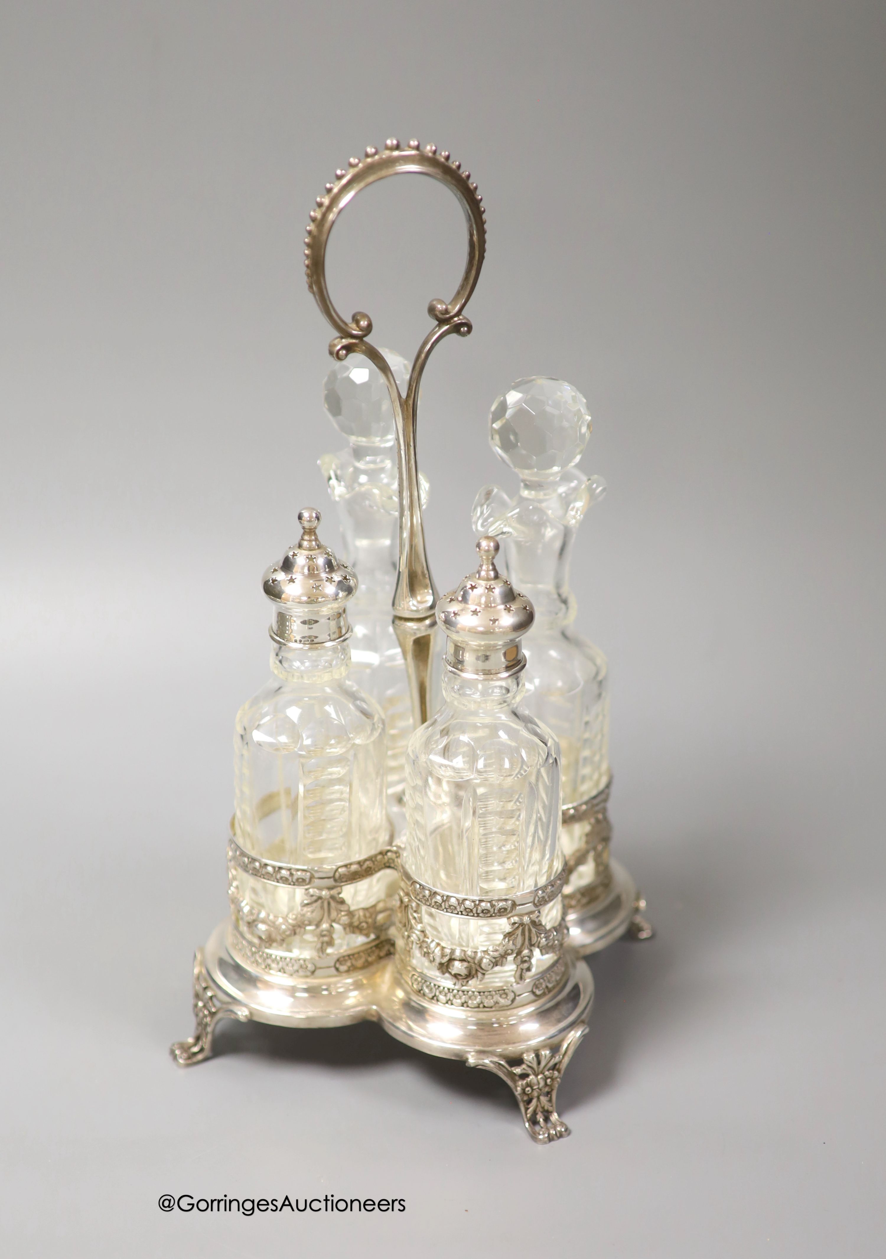 A 20th century Portuguese silver cruet stand, with four bottles, two with silver mounts, Oporto mark, height 30.5cm
